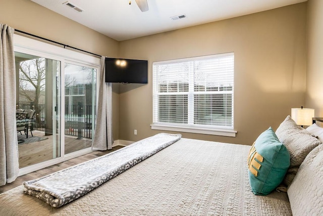 bedroom featuring access to exterior, ceiling fan, and wood-type flooring