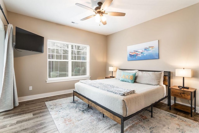 bedroom featuring ceiling fan and dark wood-type flooring