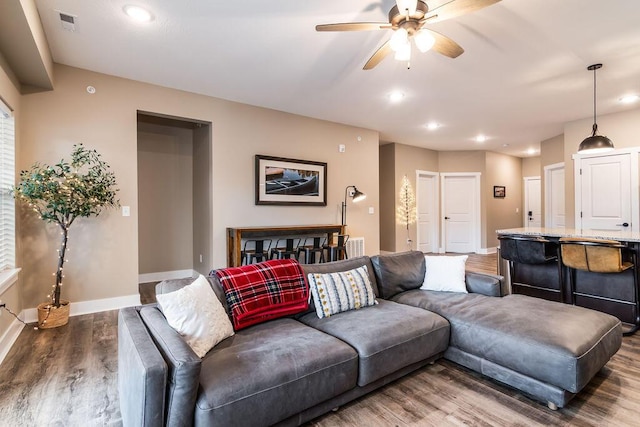 living room with ceiling fan and wood-type flooring