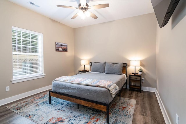 bedroom with ceiling fan and dark wood-type flooring