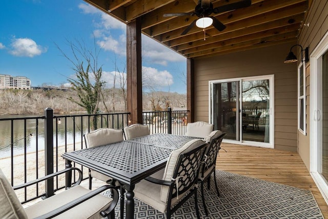 exterior space featuring ceiling fan and a water view