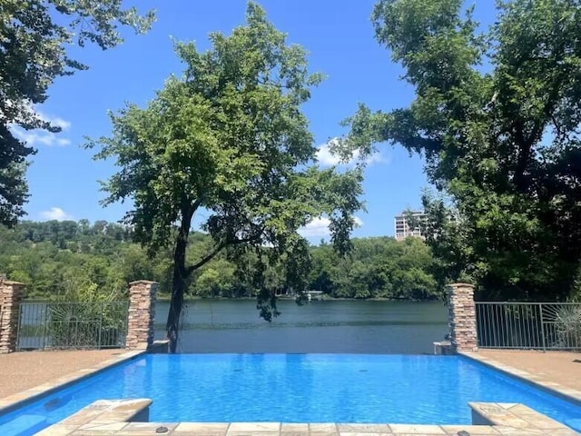 view of swimming pool featuring a water view