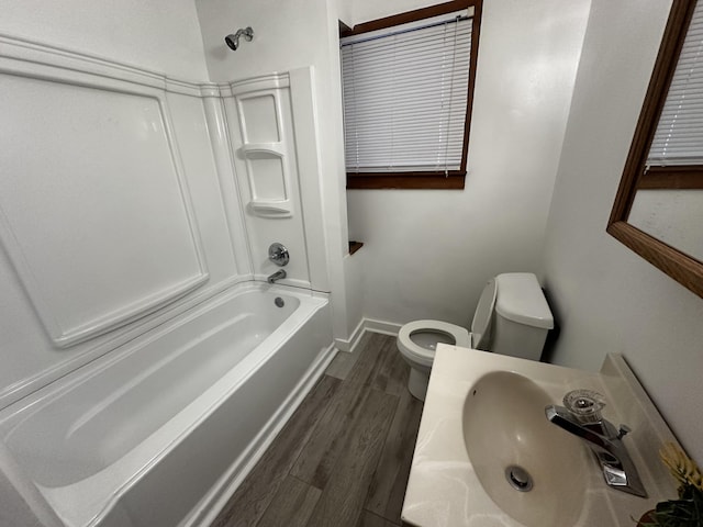 full bathroom featuring hardwood / wood-style floors, toilet, sink, and shower / washtub combination