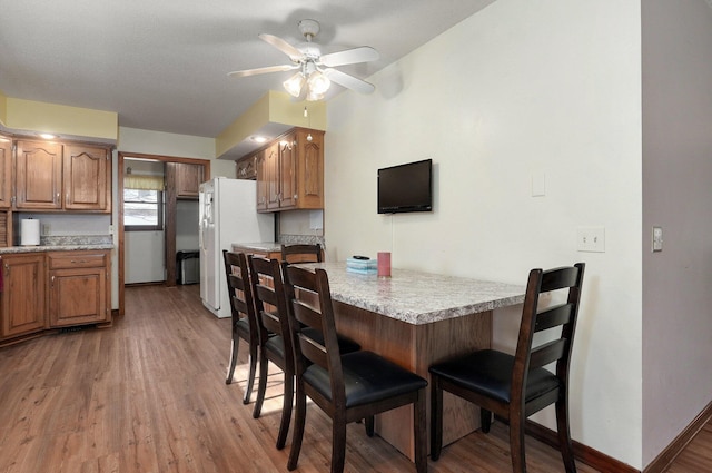 dining room featuring ceiling fan and hardwood / wood-style flooring