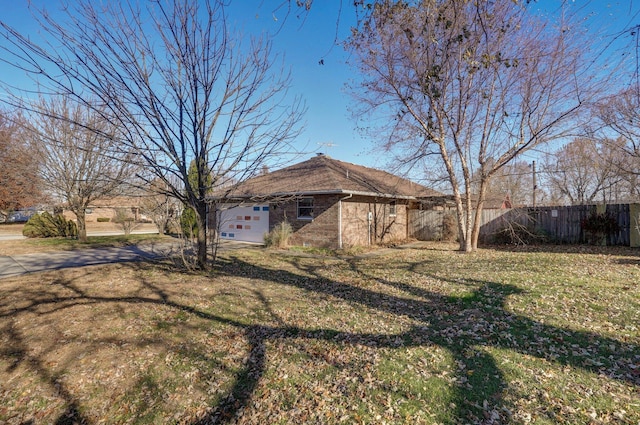 view of front of house with a garage and a front lawn