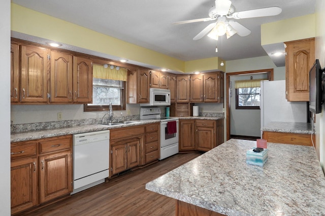 kitchen with white appliances, dark wood-type flooring, sink, ceiling fan, and plenty of natural light