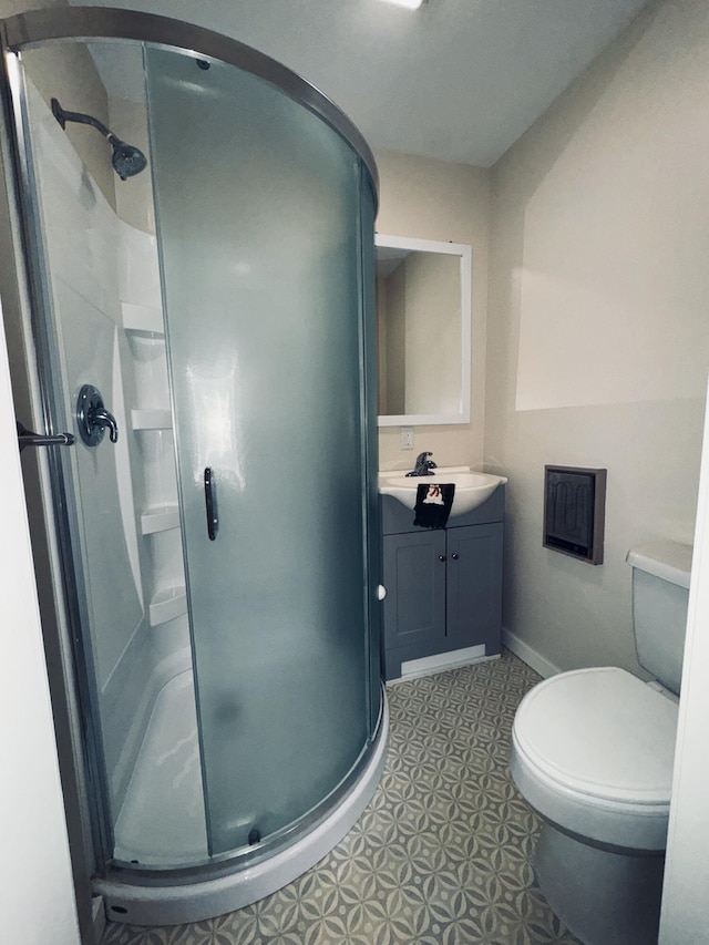 bathroom featuring vanity, an enclosed shower, and toilet