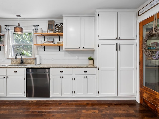 kitchen featuring white cabinetry, sink, light stone counters, dark hardwood / wood-style flooring, and decorative light fixtures