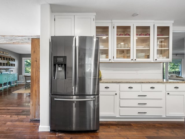 kitchen with white cabinetry, light stone countertops, stainless steel fridge with ice dispenser, and dark wood-type flooring