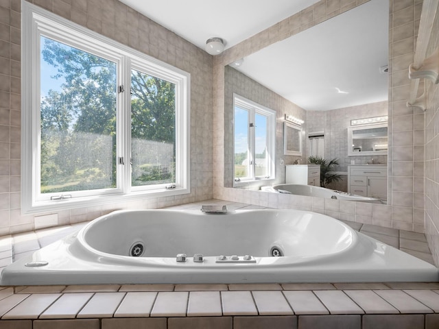 bathroom featuring vanity and a relaxing tiled tub