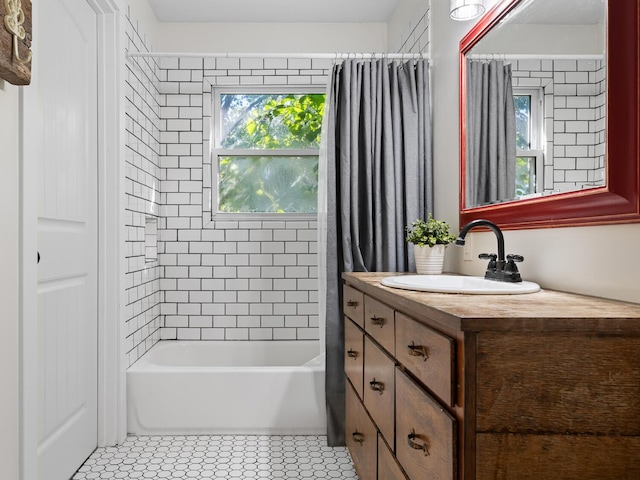 bathroom featuring tile patterned flooring, shower / tub combo, and vanity