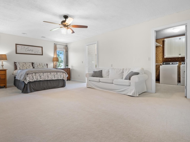 carpeted bedroom featuring washing machine and dryer, ceiling fan, and a textured ceiling