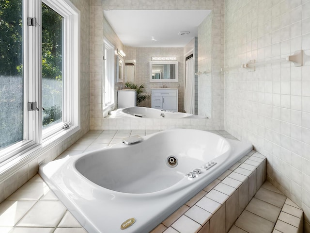 bathroom featuring tile patterned flooring and a relaxing tiled tub