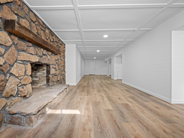 unfurnished living room featuring a fireplace and light hardwood / wood-style flooring