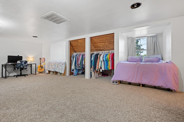 bedroom with carpet and multiple closets