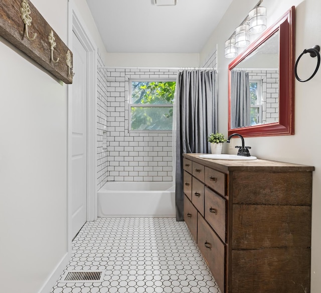 bathroom with tile patterned flooring, shower / tub combo, and vanity