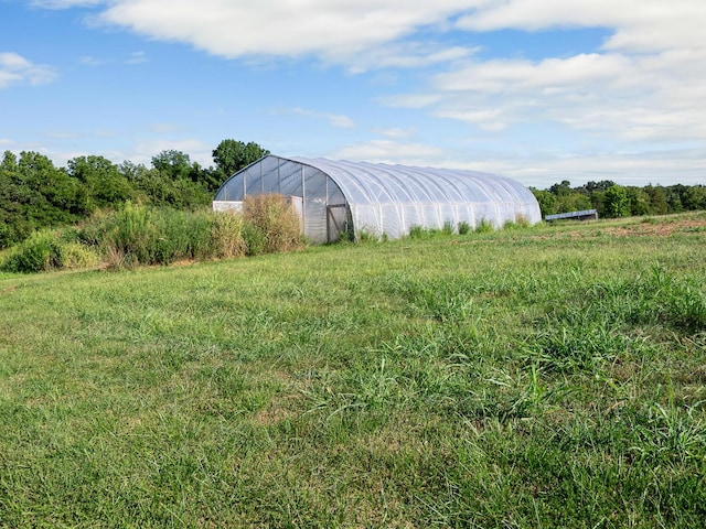 view of yard featuring an outbuilding and a rural view