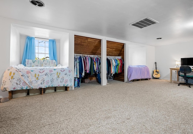 bedroom with carpet and two closets