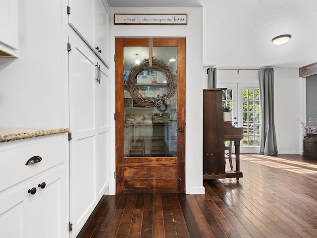 corridor featuring dark hardwood / wood-style flooring and french doors