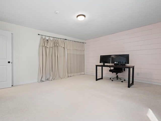 office area with wooden walls and carpet floors