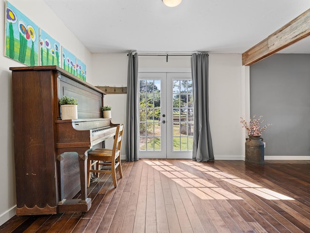 misc room with beam ceiling, french doors, and wood-type flooring