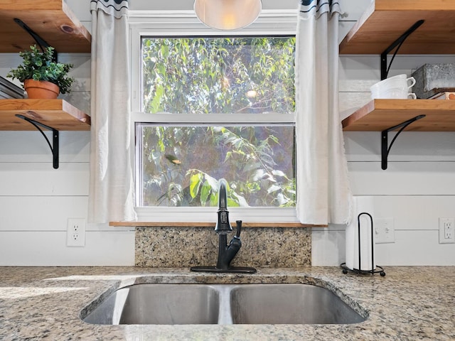 details with light stone countertops and sink