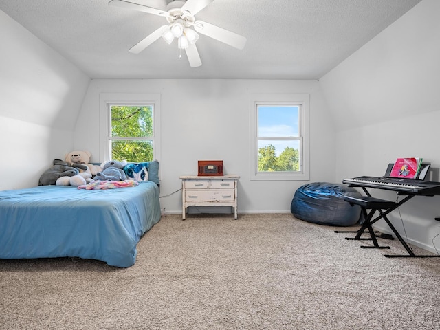 carpeted bedroom with a textured ceiling, ceiling fan, and lofted ceiling