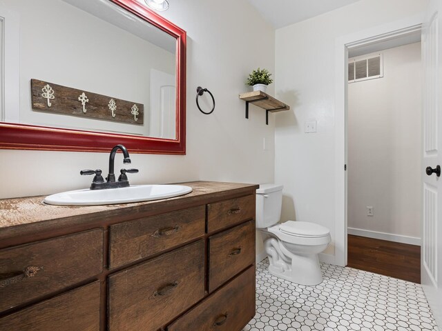 bathroom with vanity and toilet