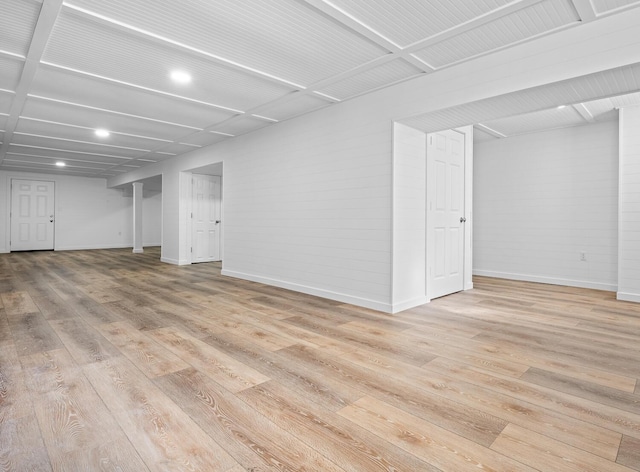 basement with light hardwood / wood-style flooring