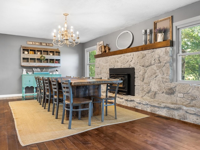 dining area featuring dark hardwood / wood-style floors and an inviting chandelier