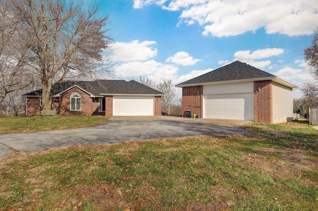 single story home with a front lawn and a garage