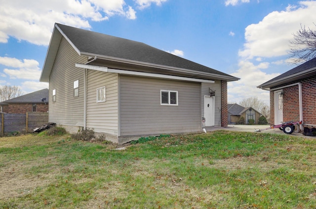 rear view of property with a yard