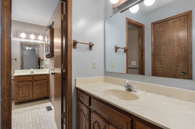 bathroom with vanity and a textured ceiling