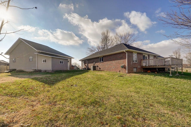 view of side of home with a wooden deck and a lawn