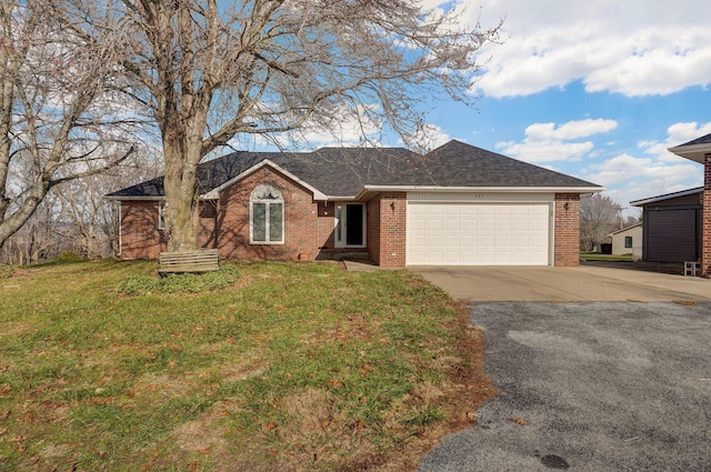 single story home featuring a garage and a front yard