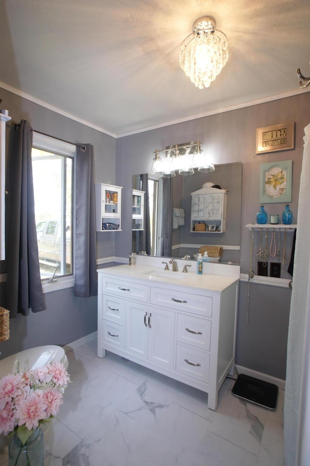 bathroom with vanity, crown molding, and a textured ceiling