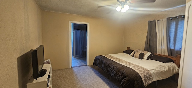 bedroom featuring a textured ceiling, connected bathroom, light colored carpet, and ceiling fan