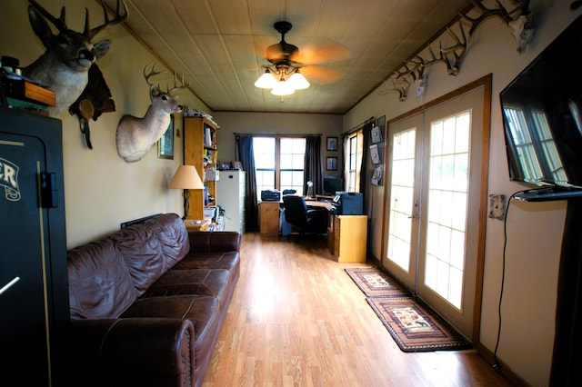 living room with french doors, light hardwood / wood-style floors, and ceiling fan