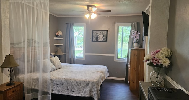 bedroom with a textured ceiling, dark wood-type flooring, ceiling fan, and crown molding