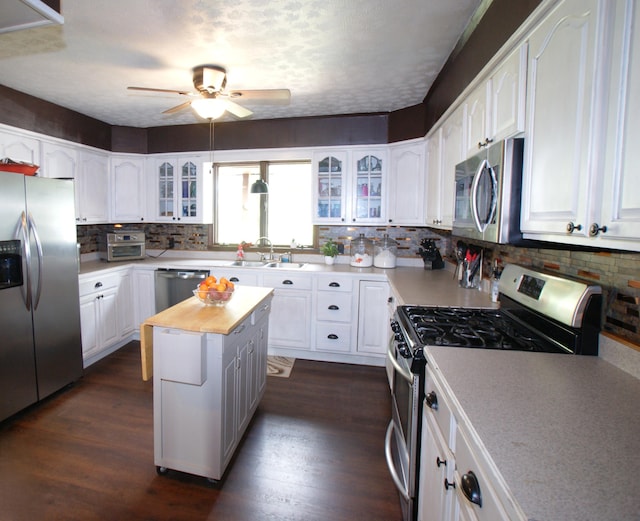 kitchen featuring white cabinetry, appliances with stainless steel finishes, and wooden counters