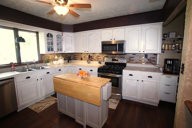 kitchen featuring white cabinets, appliances with stainless steel finishes, and sink