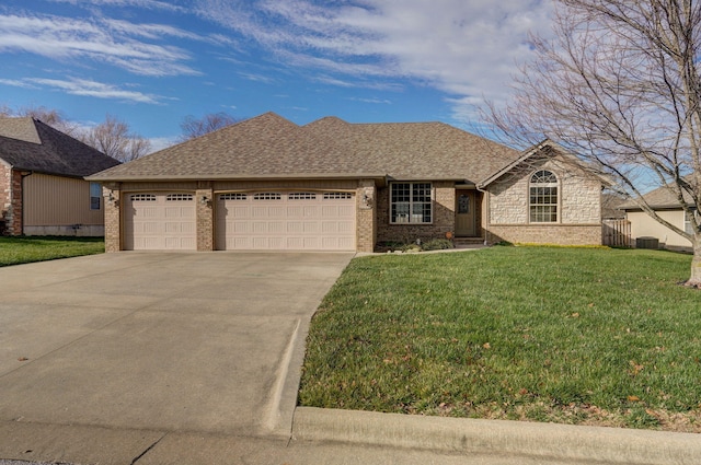 view of front of house featuring a front yard and a garage