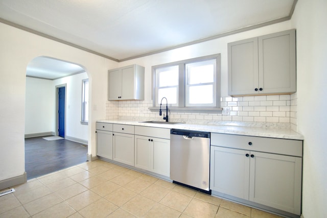 kitchen with gray cabinetry, dishwasher, sink, light tile patterned floors, and ornamental molding