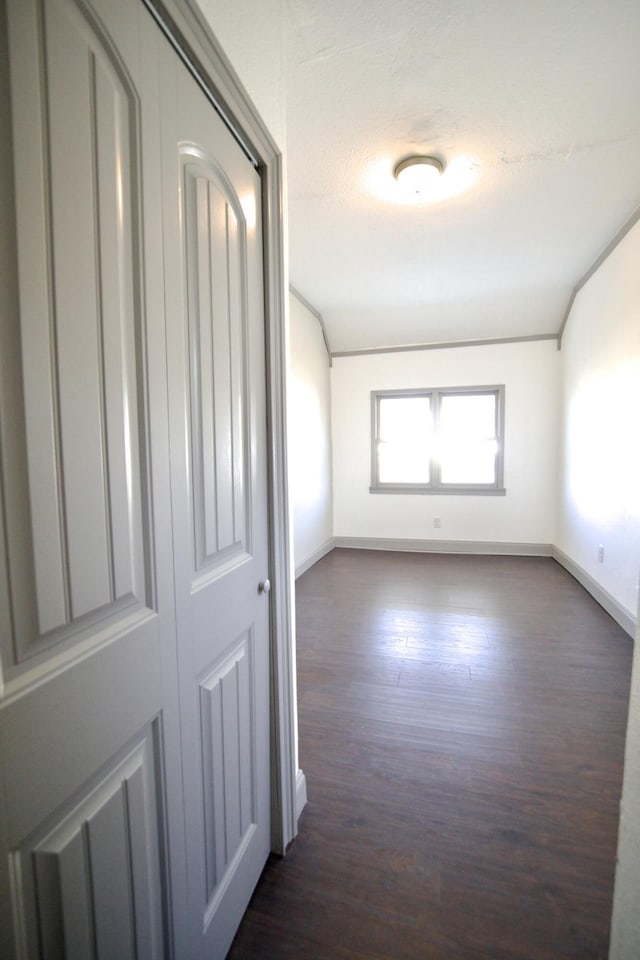 hallway with dark hardwood / wood-style flooring