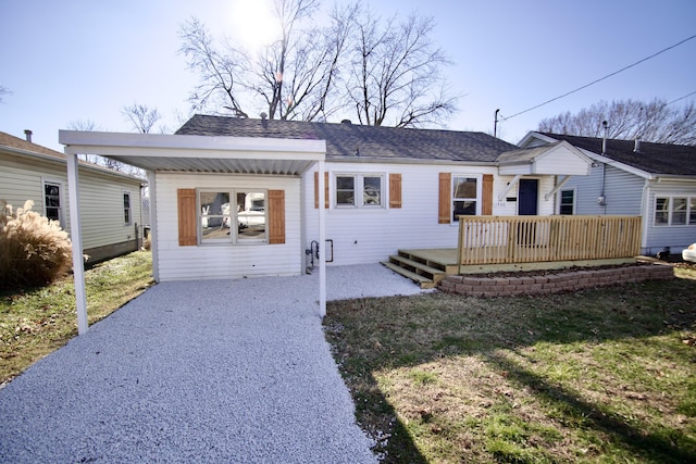 ranch-style home with a front lawn and a wooden deck