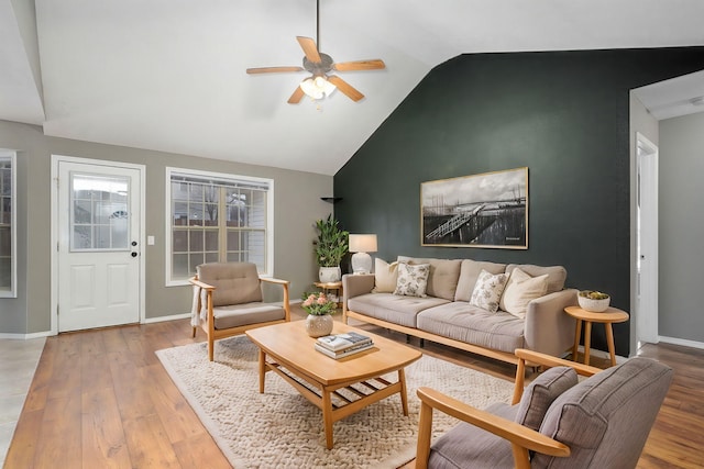 living room with ceiling fan, lofted ceiling, and hardwood / wood-style flooring