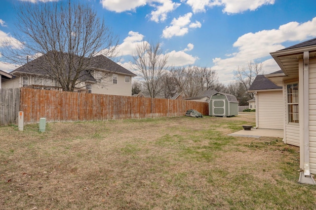 view of yard featuring a patio and a storage shed