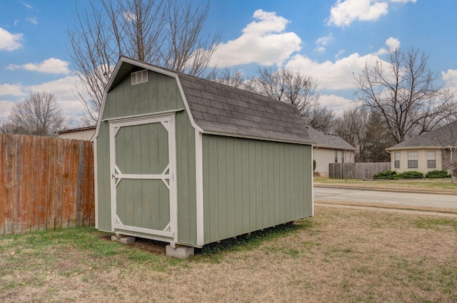 view of outbuilding featuring a lawn