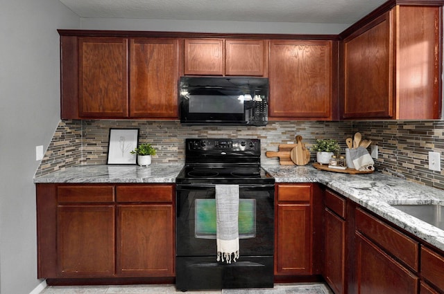 kitchen with black appliances, decorative backsplash, and light stone counters