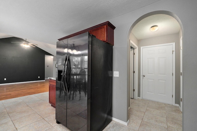 hall with light tile patterned floors and an inviting chandelier